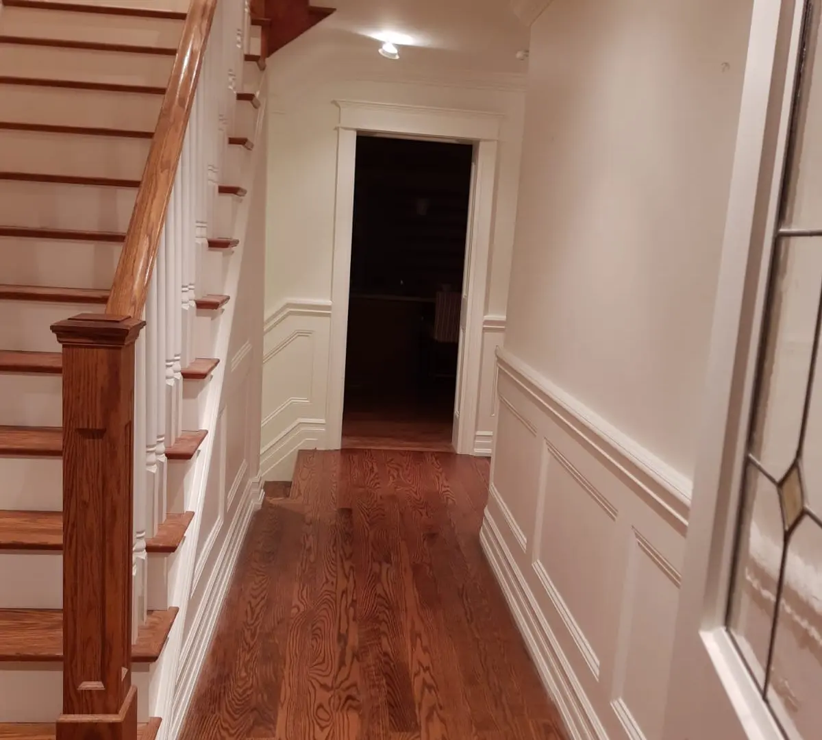 A bright, freshly repainted Toronto living room with crisp white trim and clean wall colour after a professional interior job