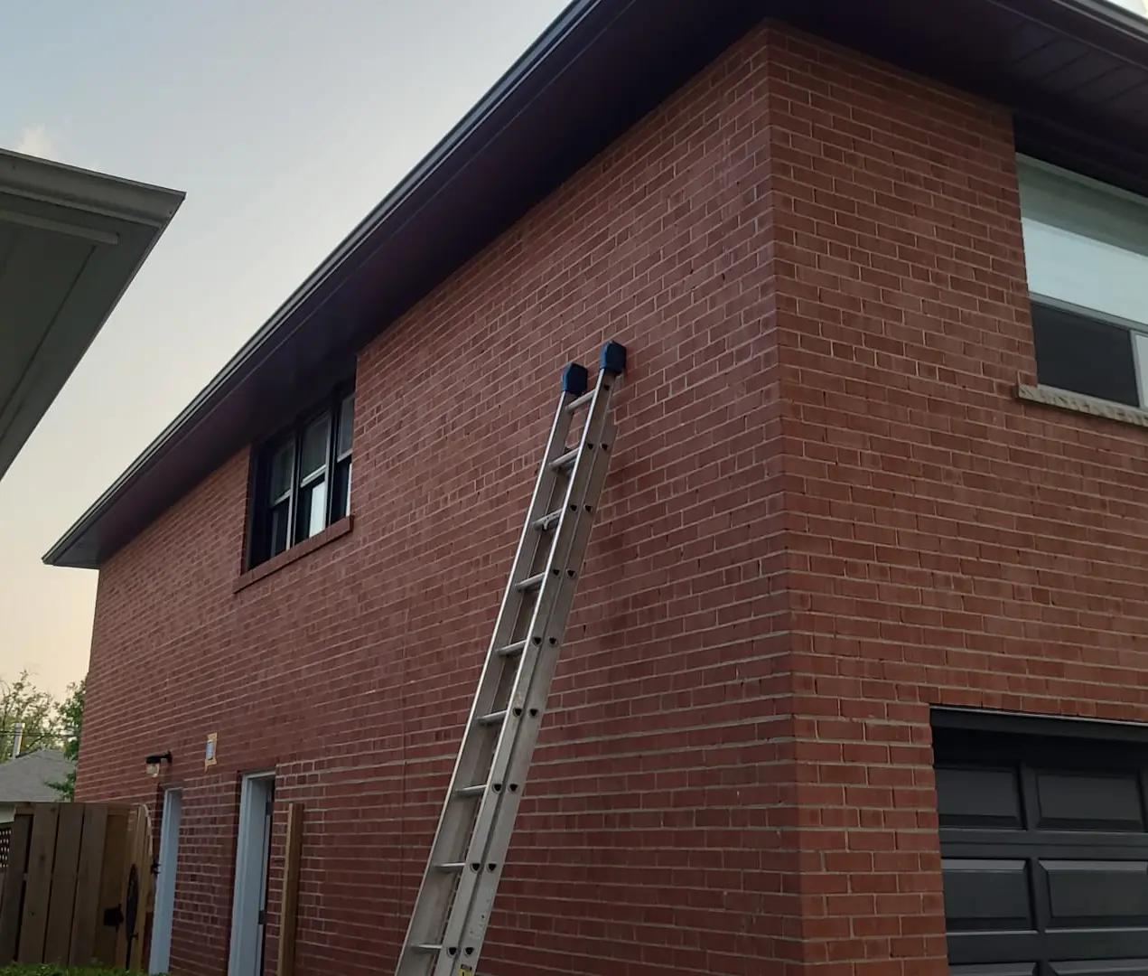 Exterior sealant joint being tooled along a Toronto home's trim during a repaint