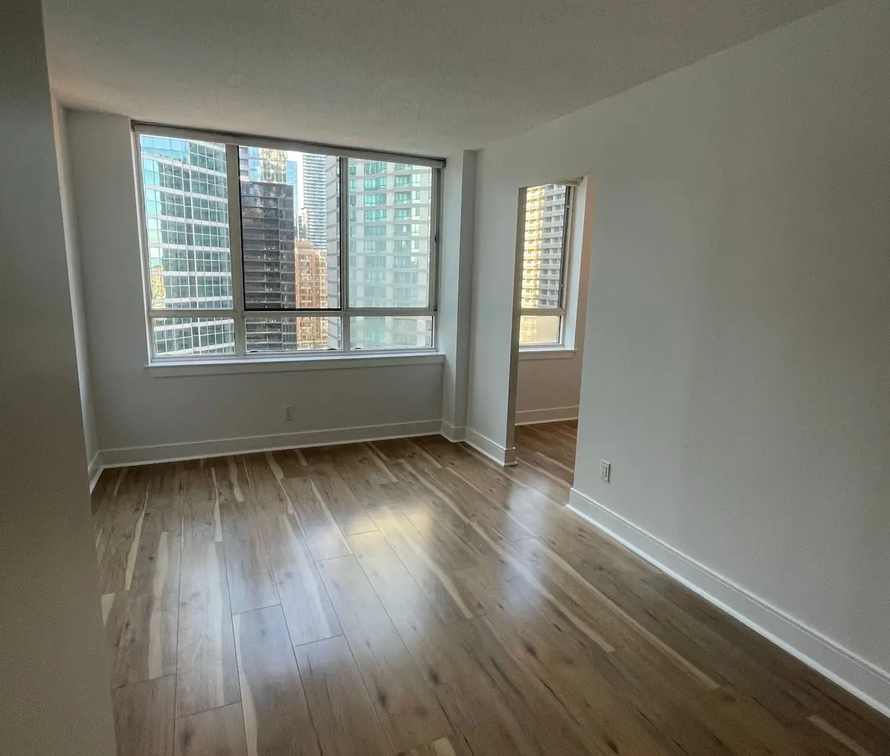 Reading the caulk beads around every window and door is the first thing I do on an exterior estimate Toronto painter inspecting failed exterior caulking around a window frame before recaulking