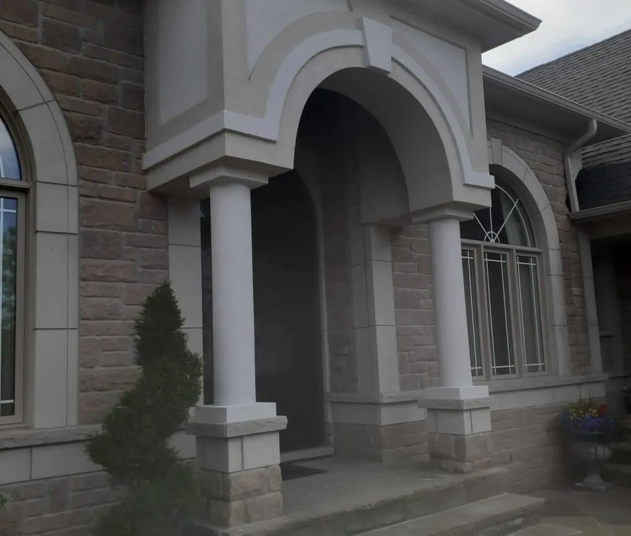 Painter inspecting a wall before a Toronto repaint to diagnose a paint defect